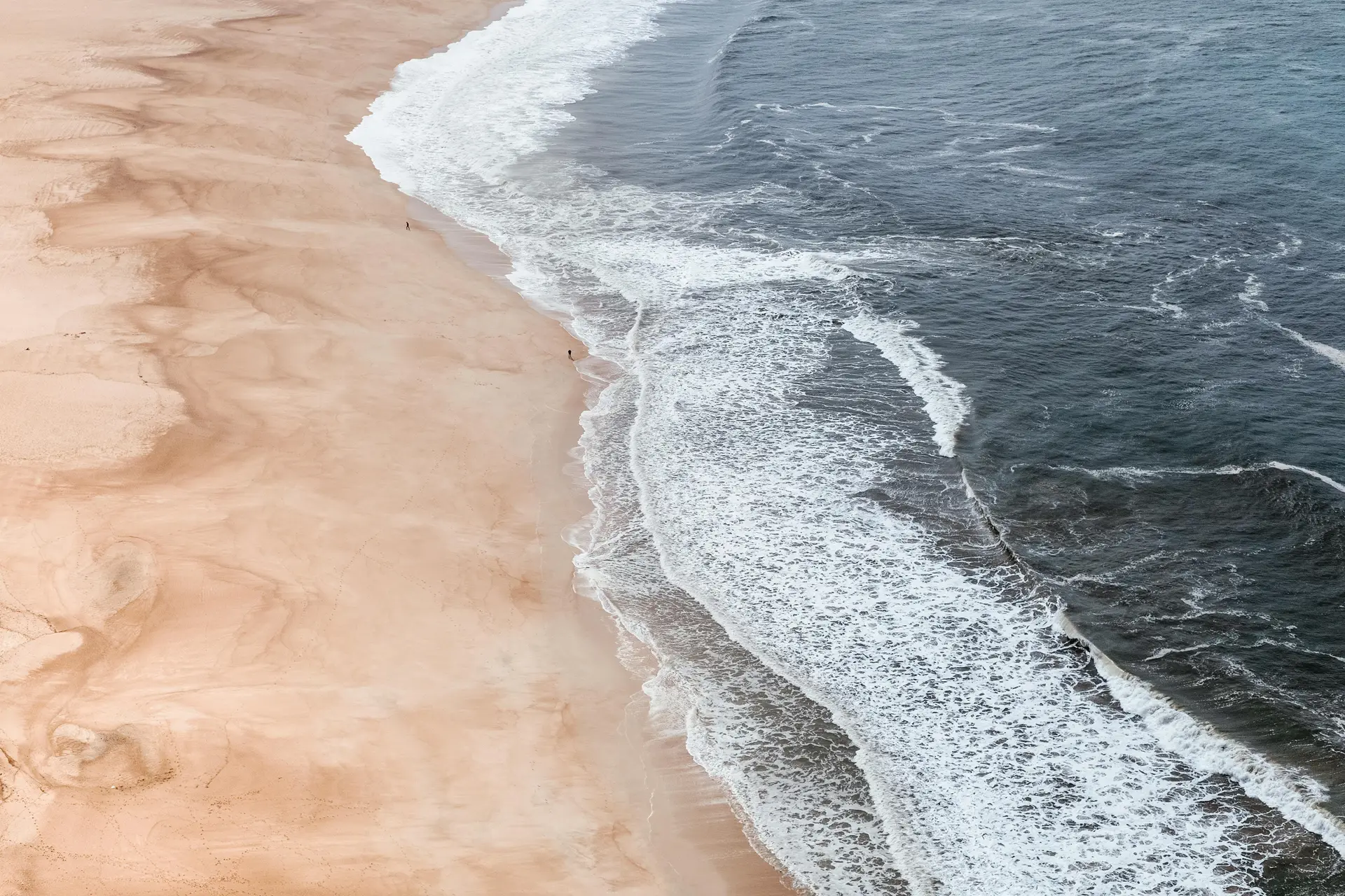 a_beach_with_waves_crashing_on_the_shore.jpg