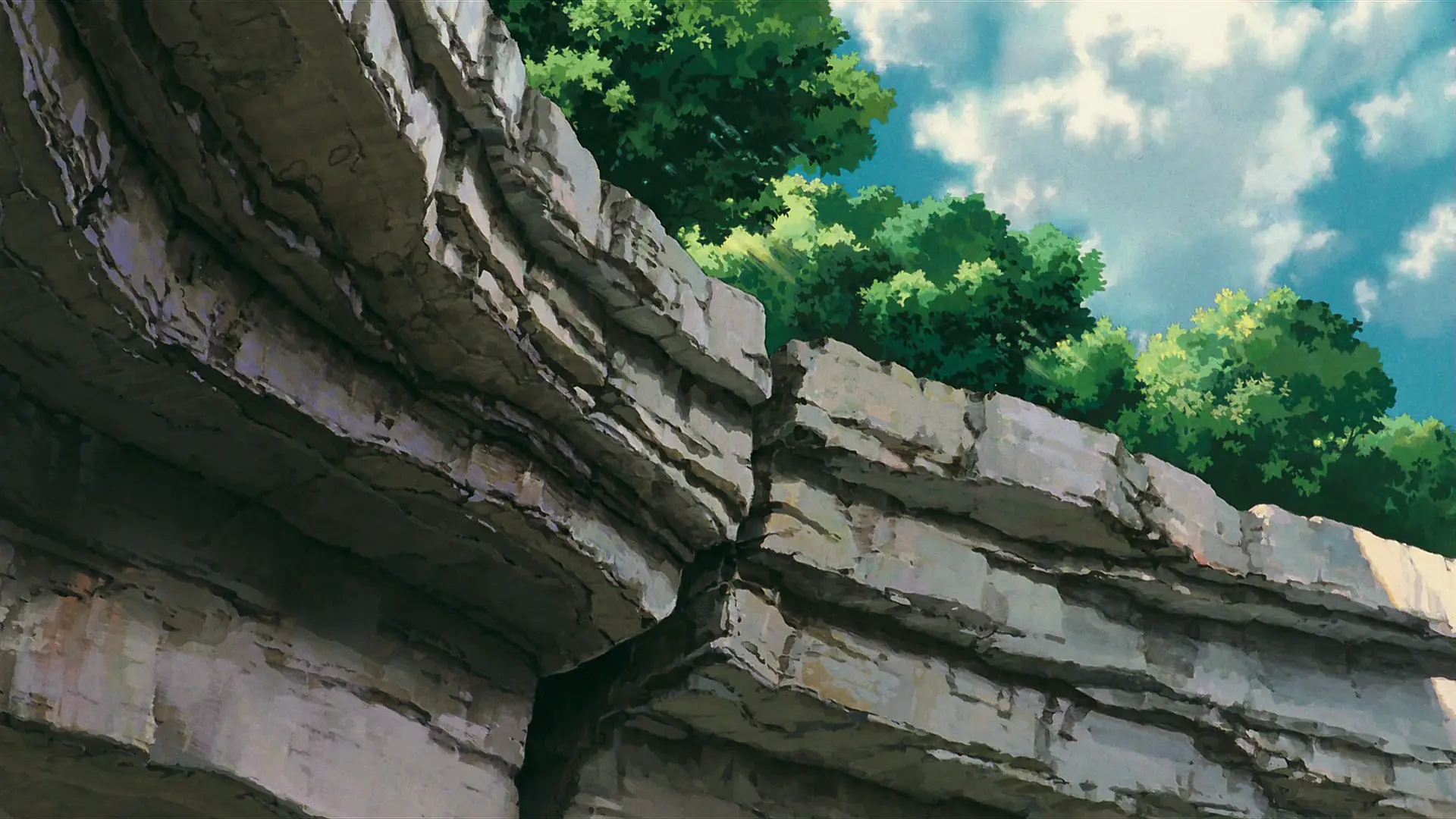 a_rock_cliff_with_trees_on_top.png