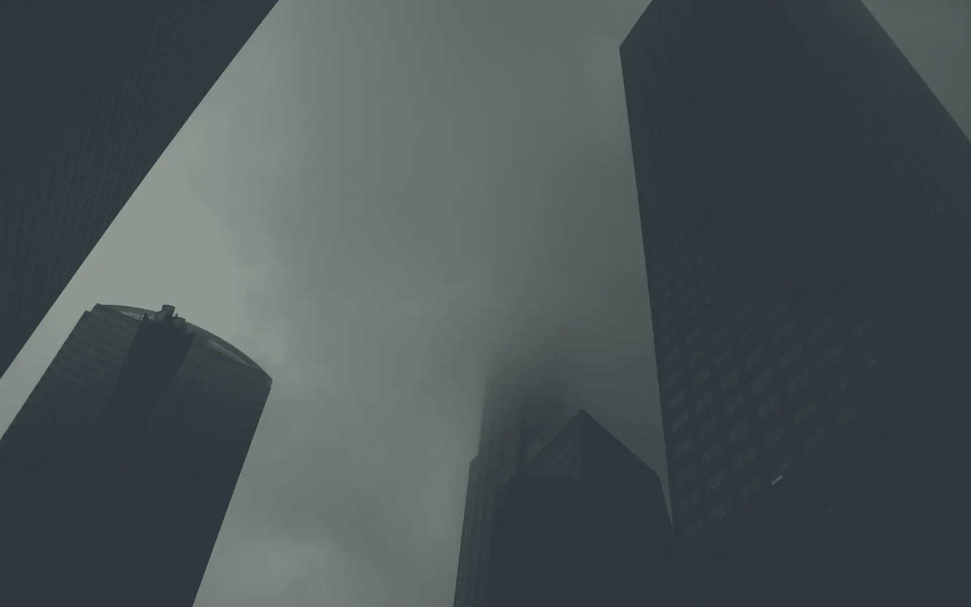 a_group_of_tall_buildings_with_fog.png