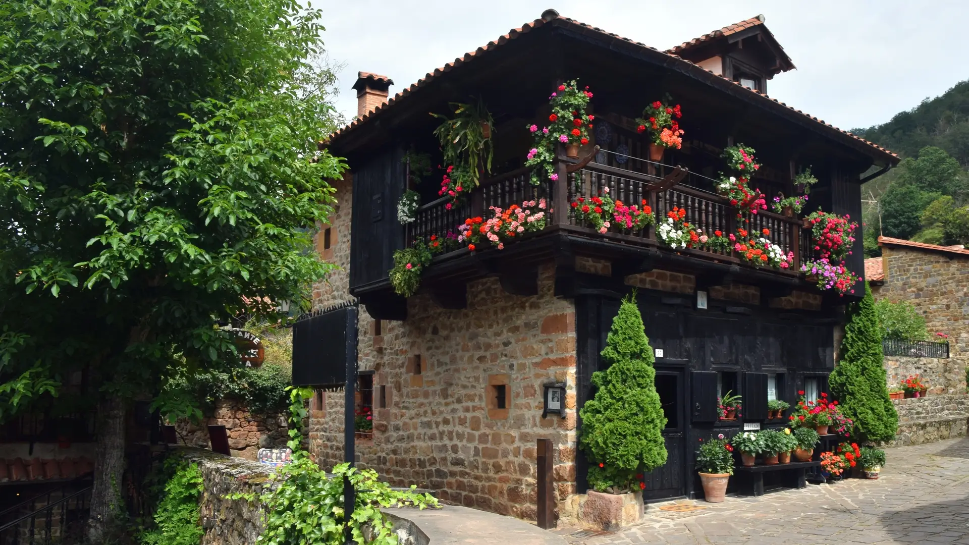 a_building_with_flowers_on_the_balcony.png