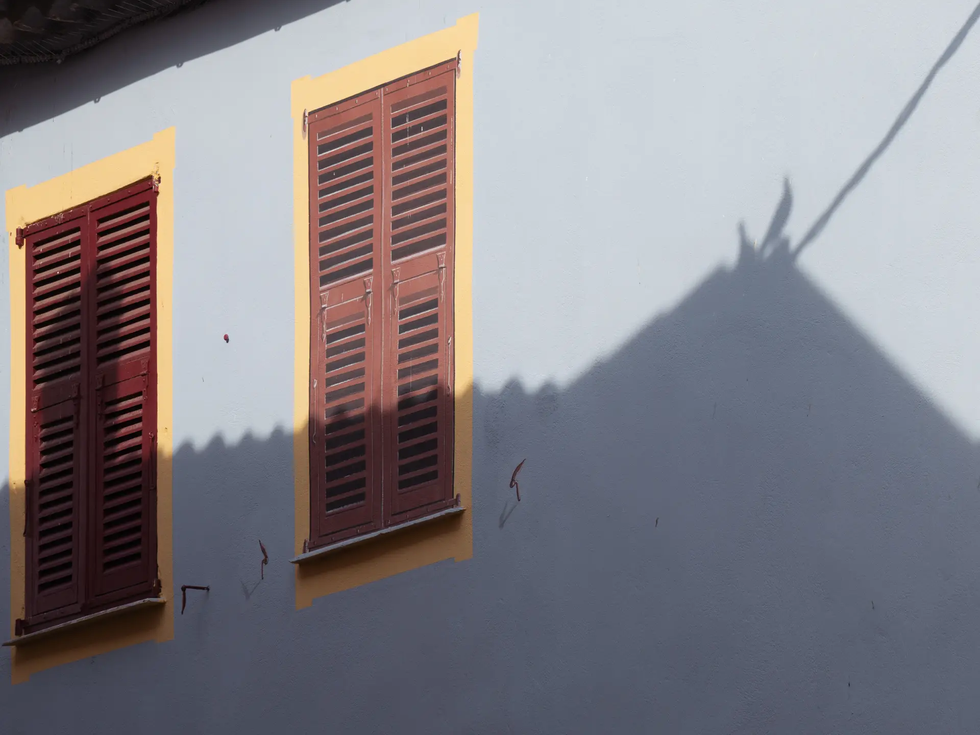 a_building_with_shutters_on_windows.jpg