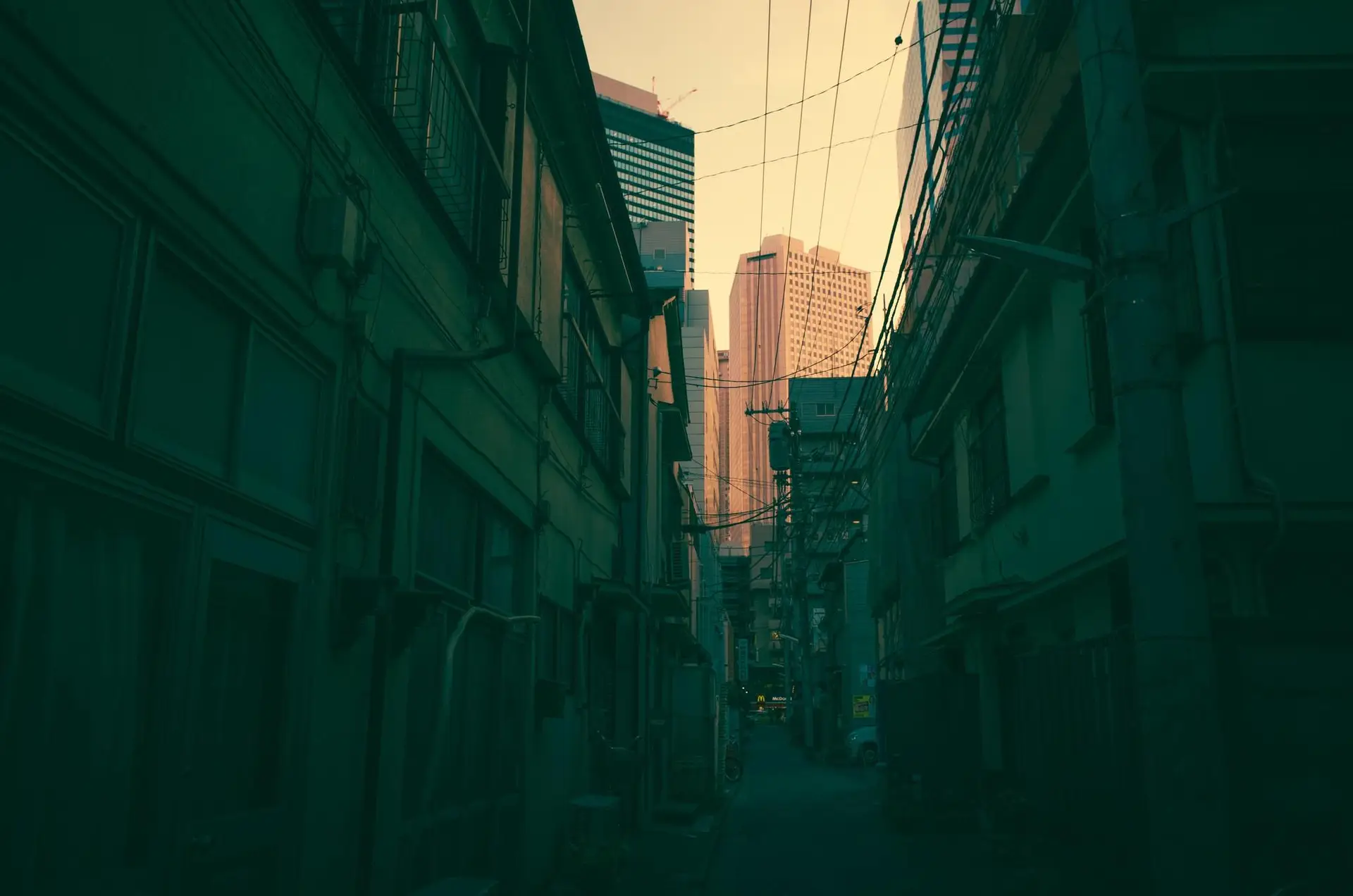 a_city_alley_with_buildings_and_power_lines.jpg