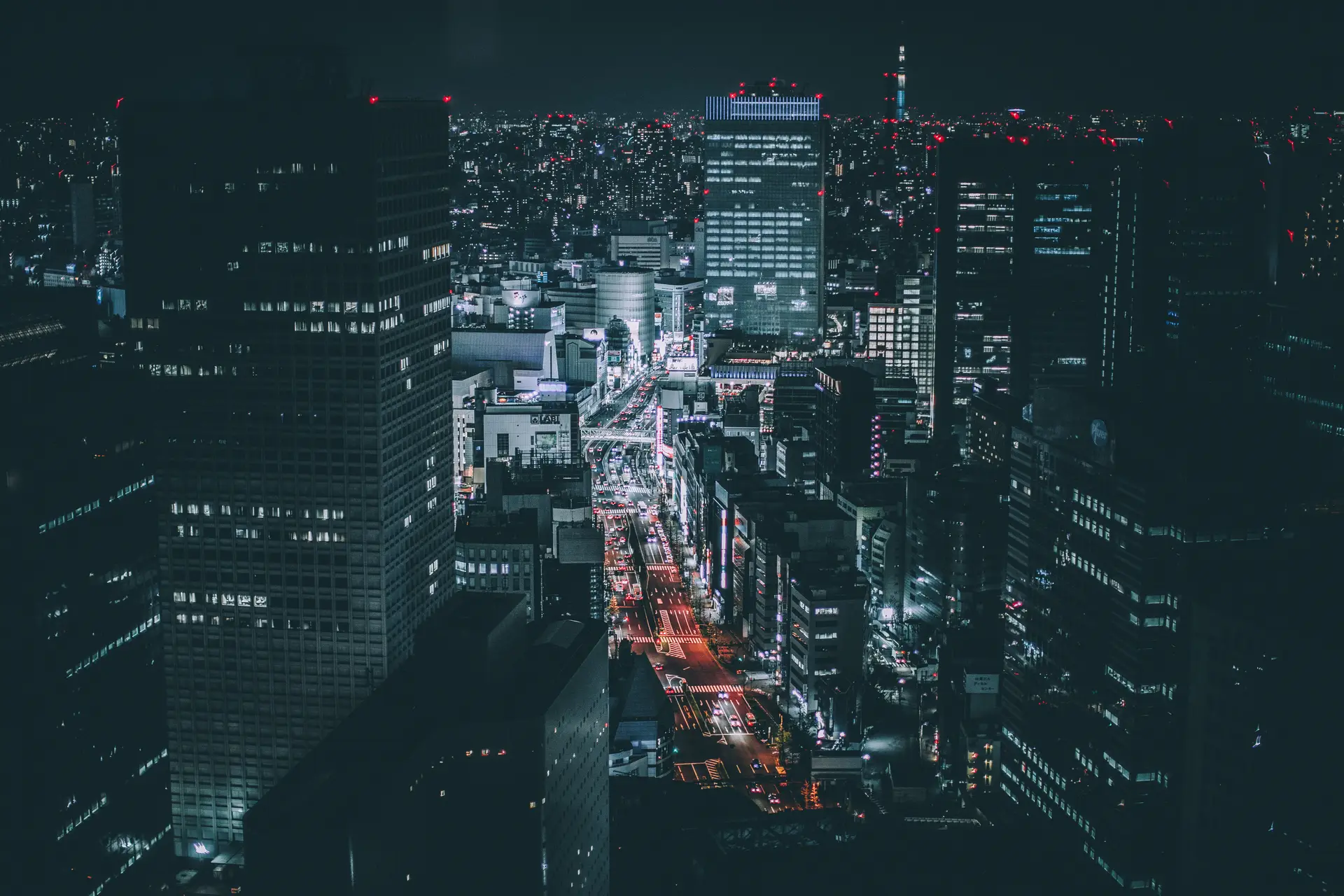 a_city_at_night_with_many_tall_buildings.jpg