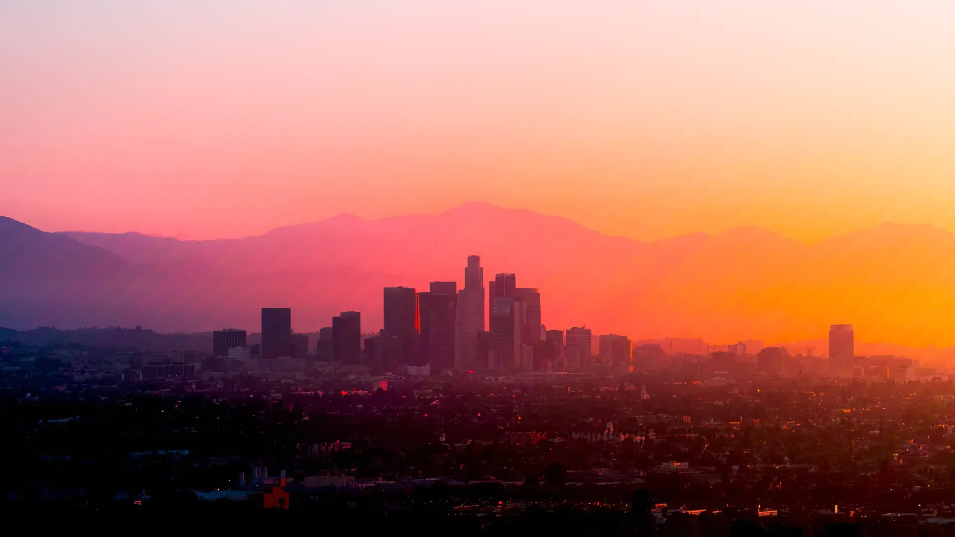 a_city_skyline_with_mountains_in_the_background.png