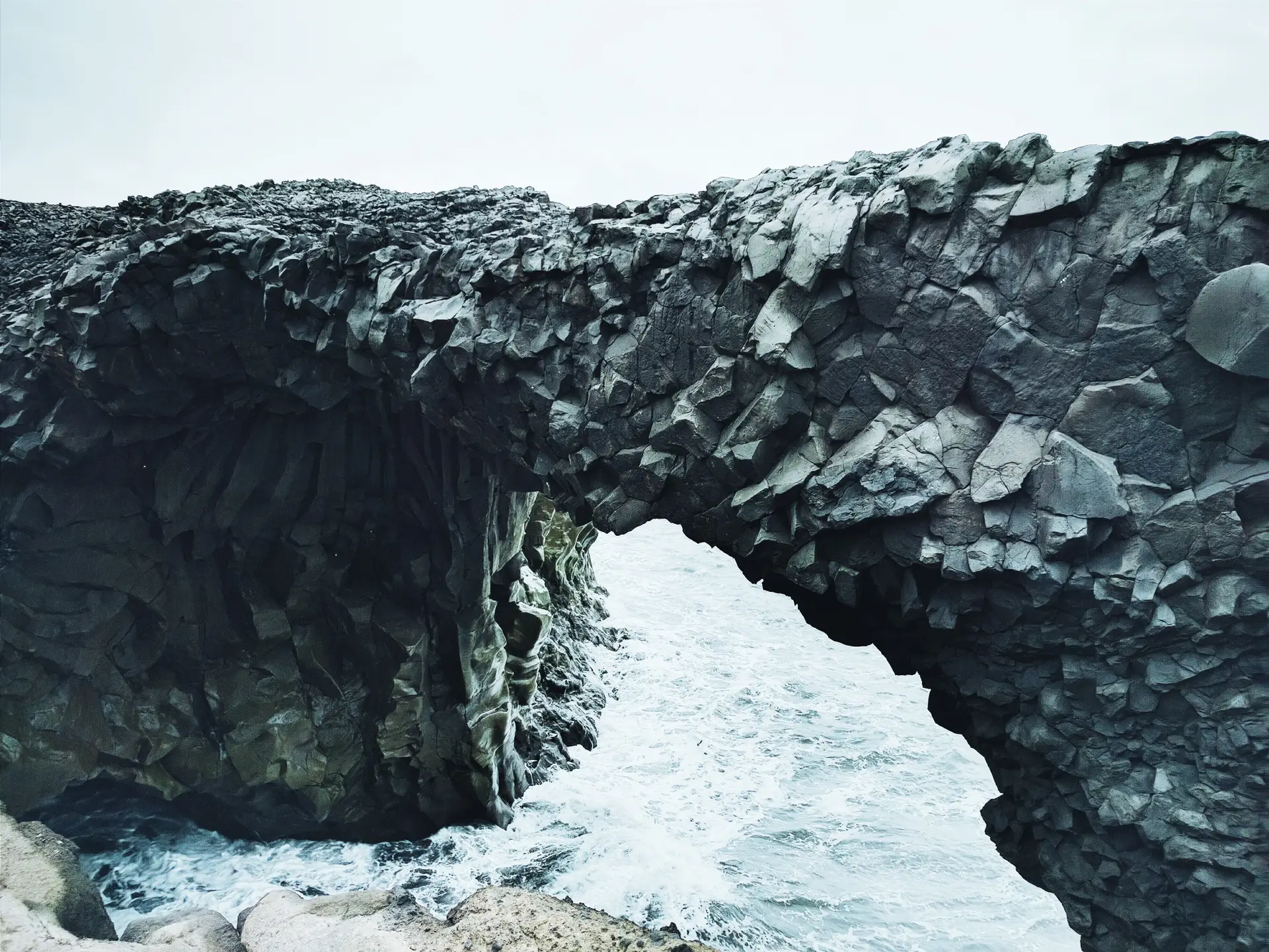 a_rock_arch_over_water.jpg