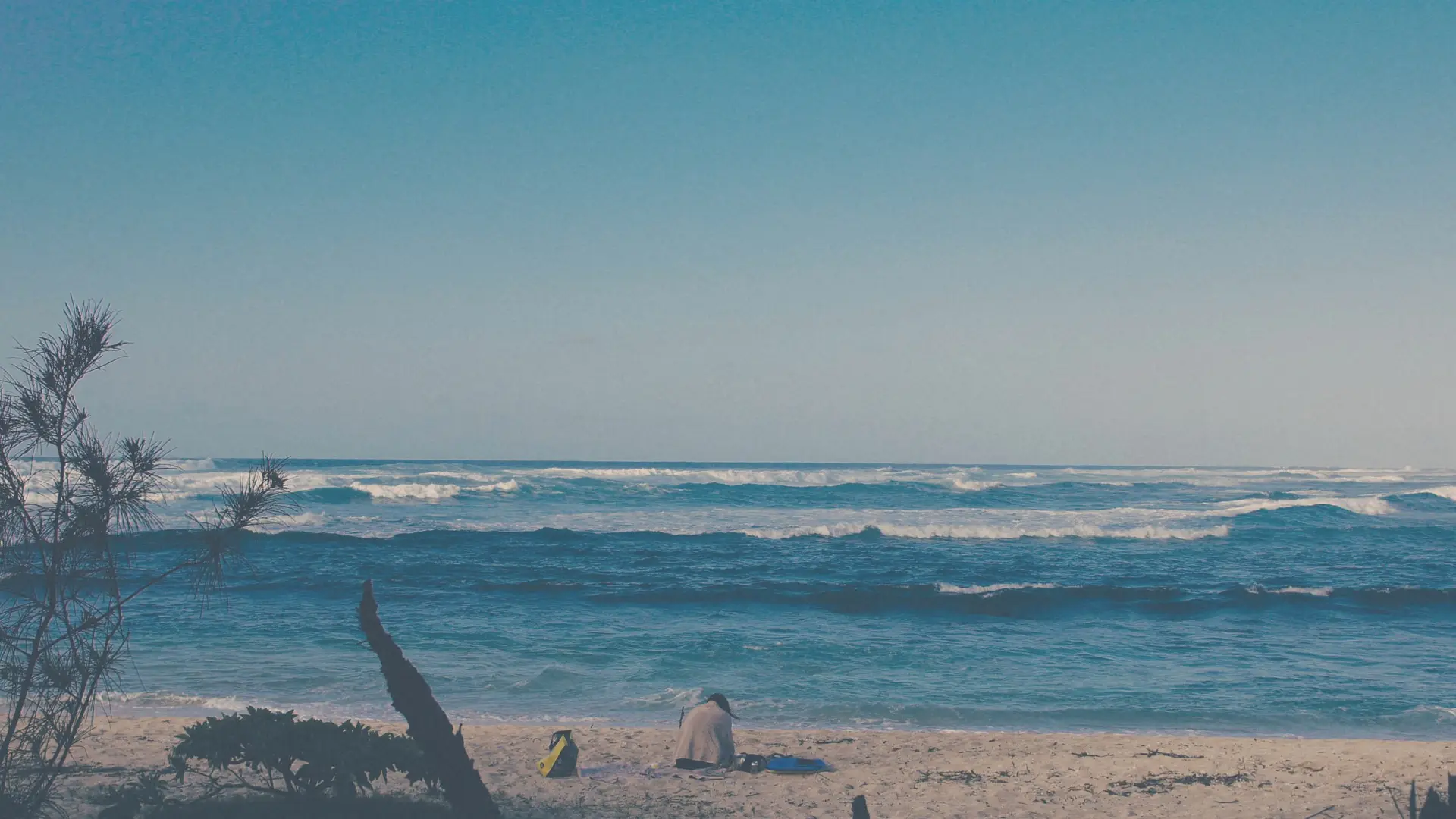 a_person_sitting_on_a_beach.jpg