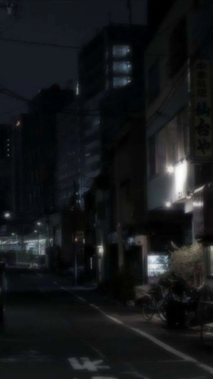 a_street_at_night_with_buildings_in_the_background.jpg