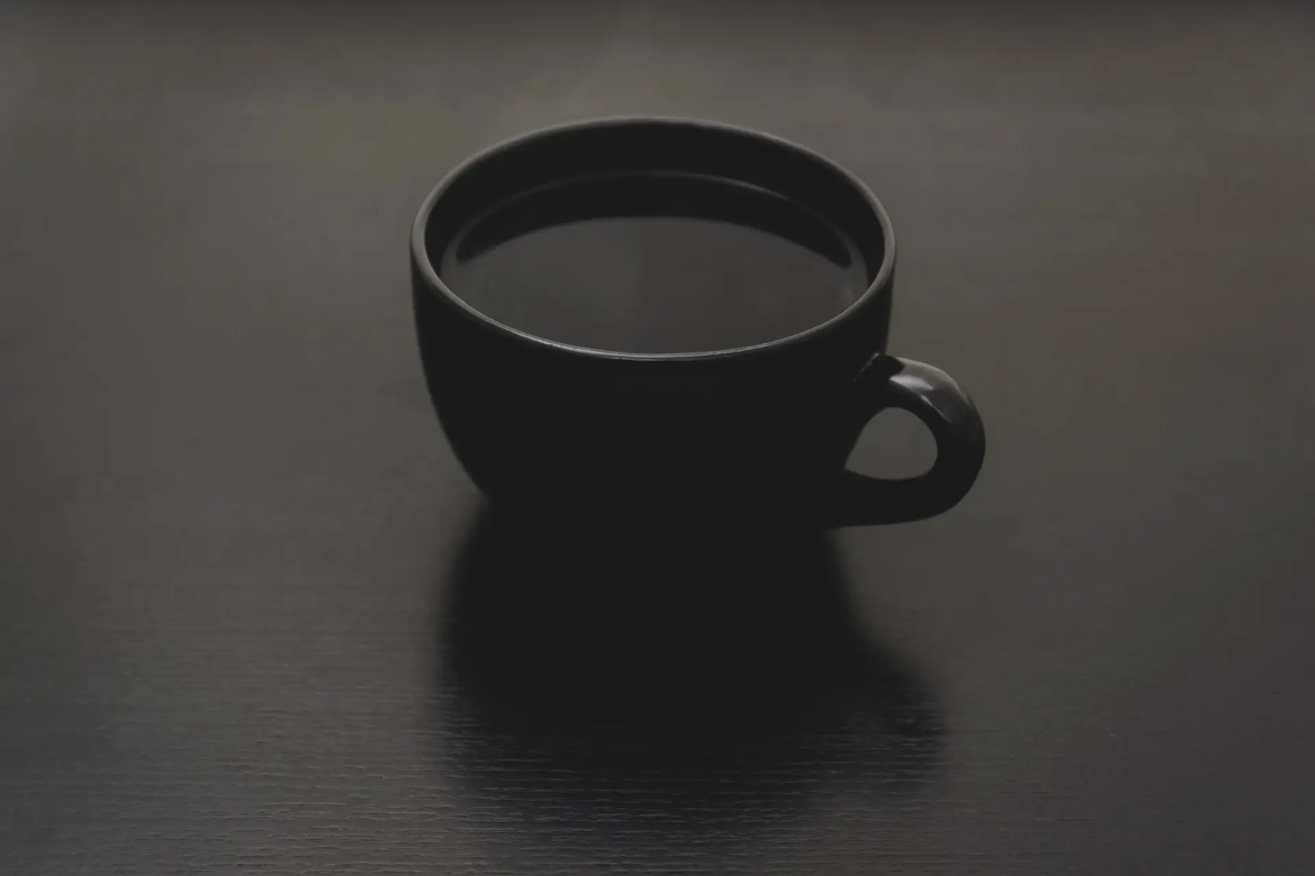 a_black_cup_with_liquid_in_it.png