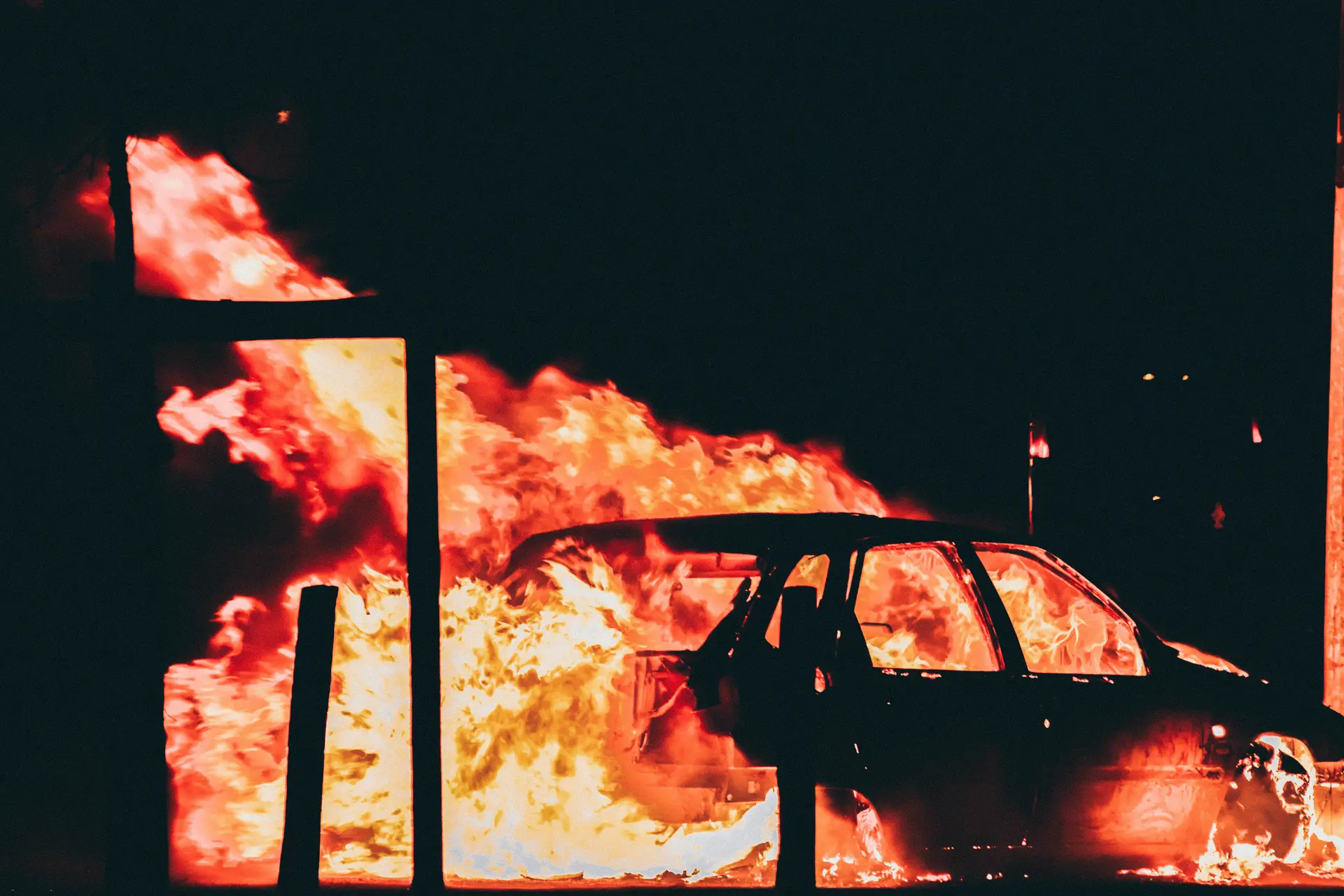 a_car_on_fire_at_night.jpg