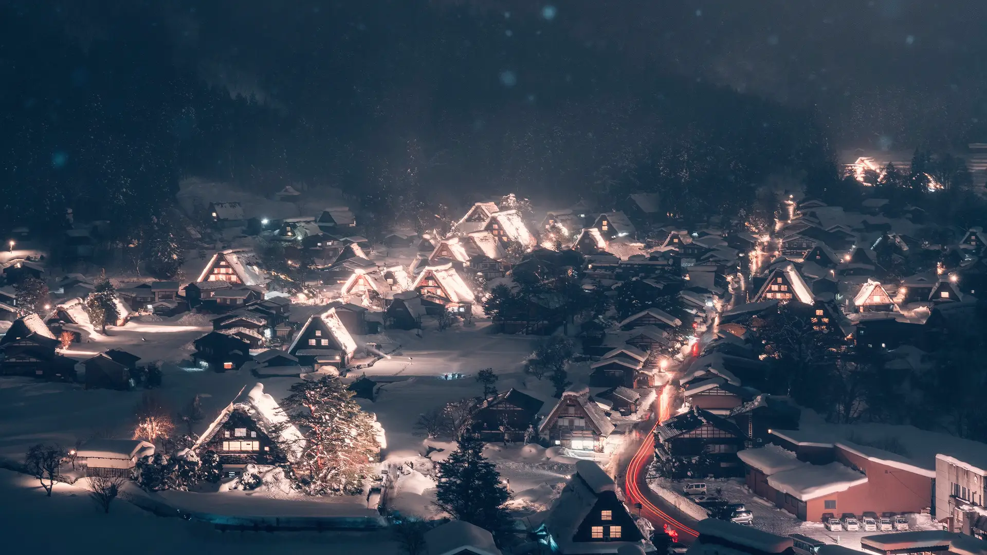 a_town_with_snow_covered_roofs_and_lights.png