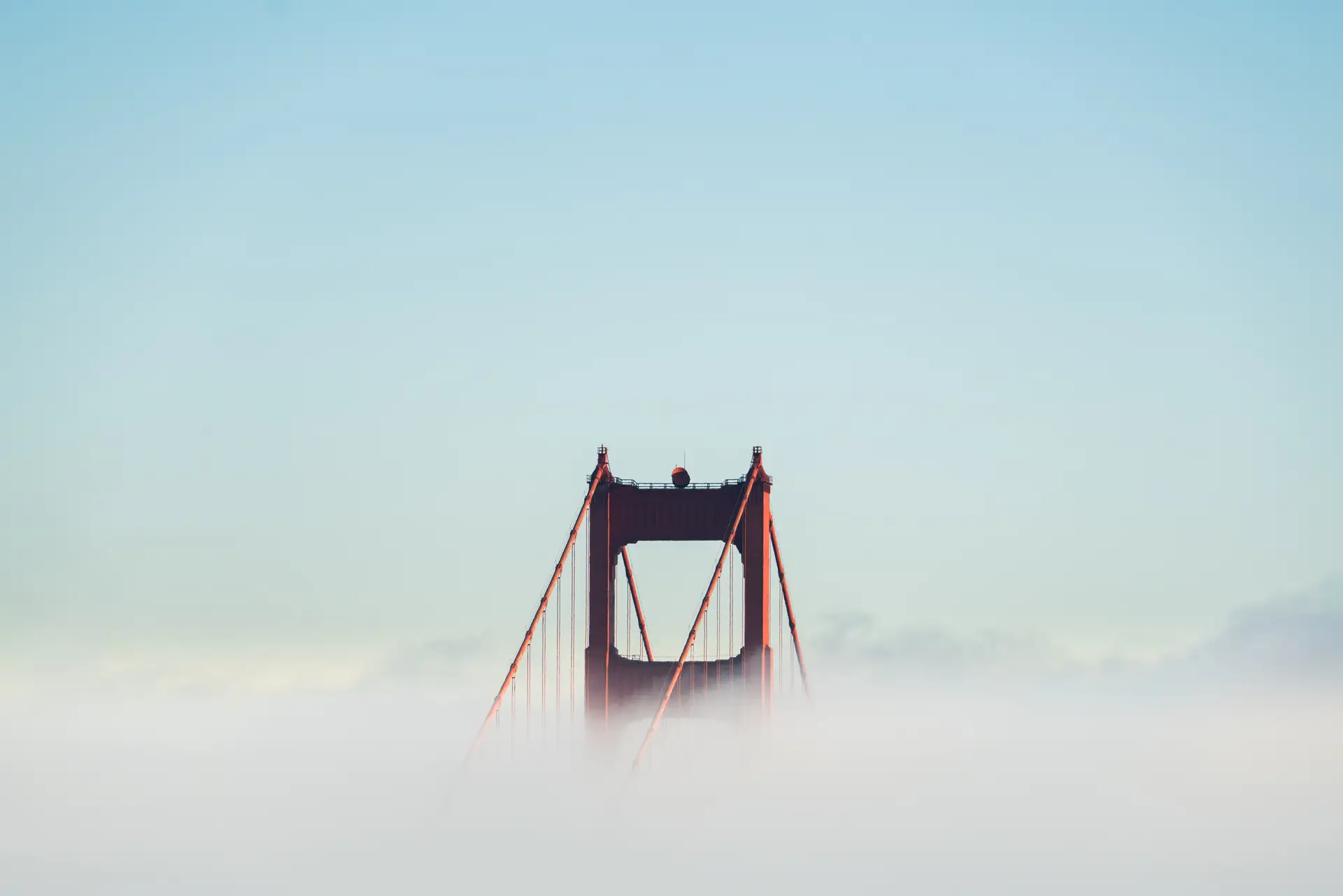 a_bridge_with_clouds_in_the_sky.jpg