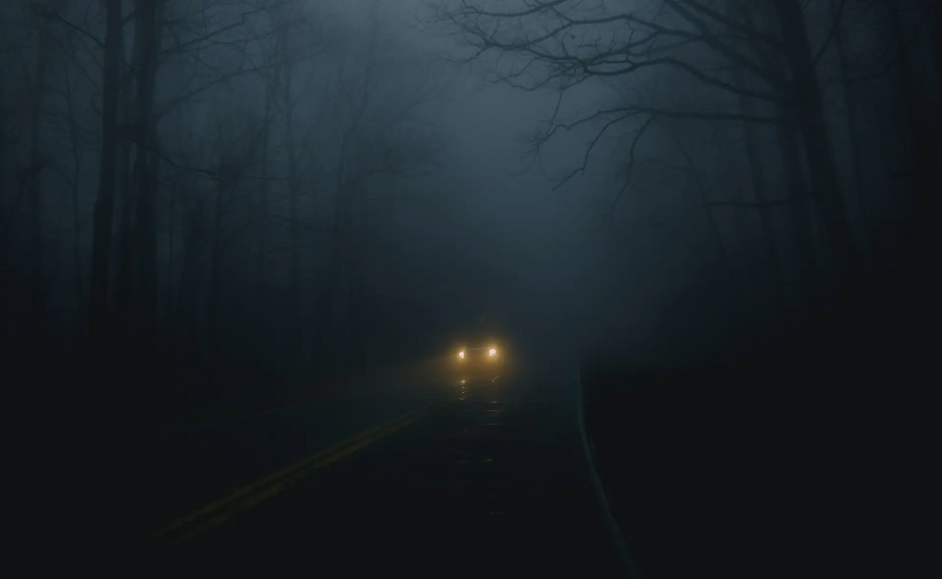 a_car_on_a_road_with_fog.jpg