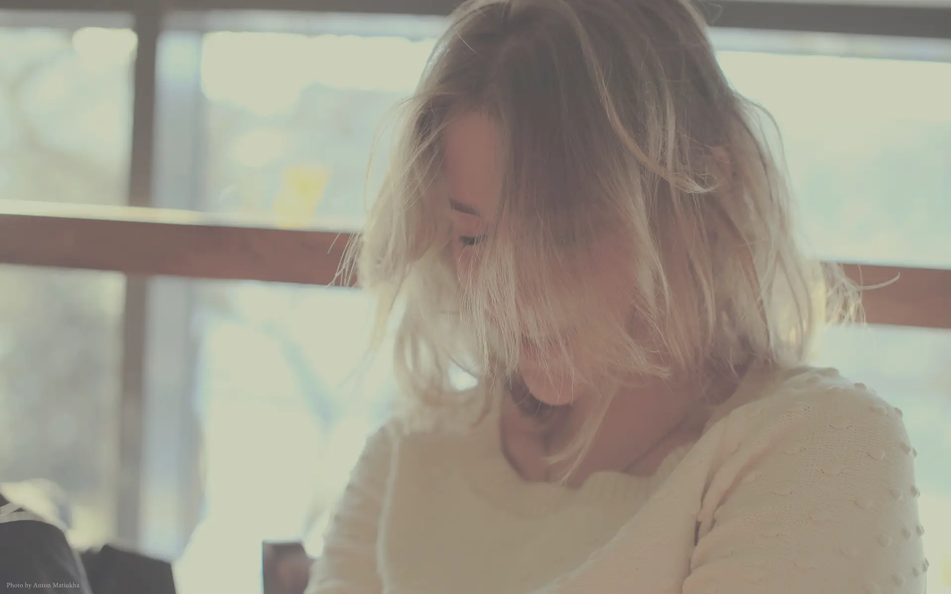 a_woman_with_her_hair_blowing_in_the_wind.jpg