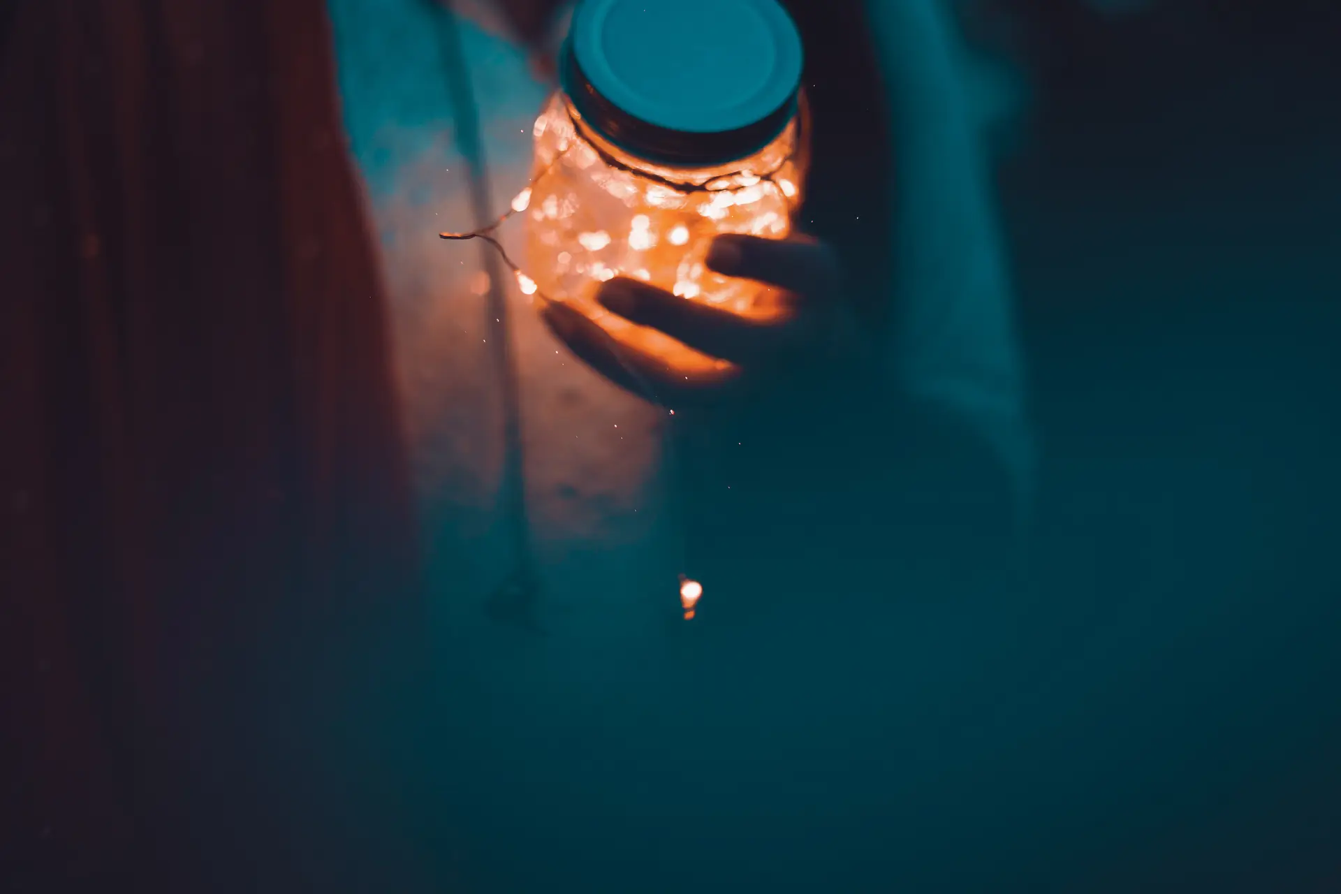 a_person_holding_a_jar_with_lights.jpg