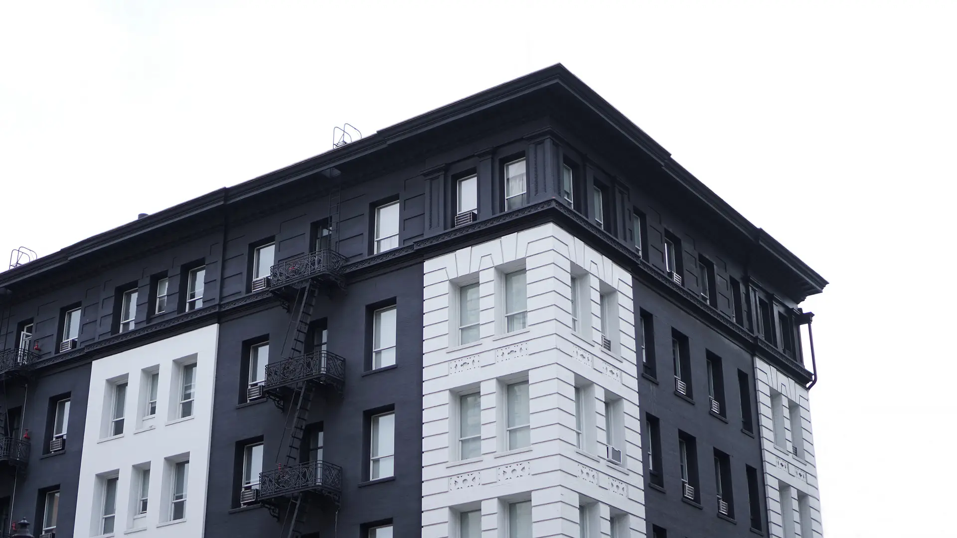 a_black_and_white_building_with_a_fire_escape.jpg