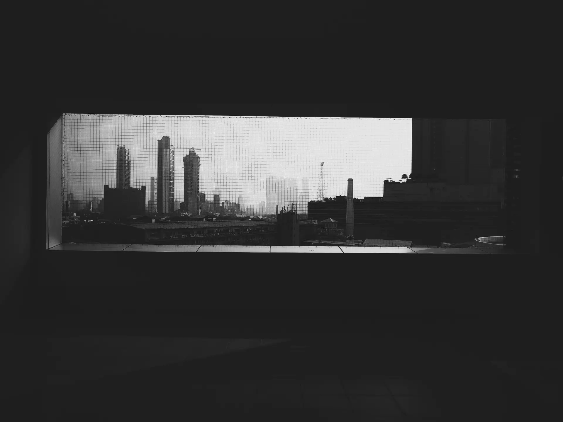 a_city_skyline_seen_through_a_window.jpg