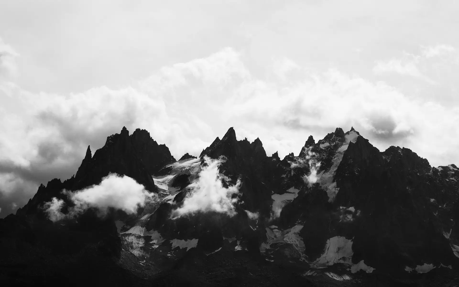 a_mountain_range_with_clouds.jpg