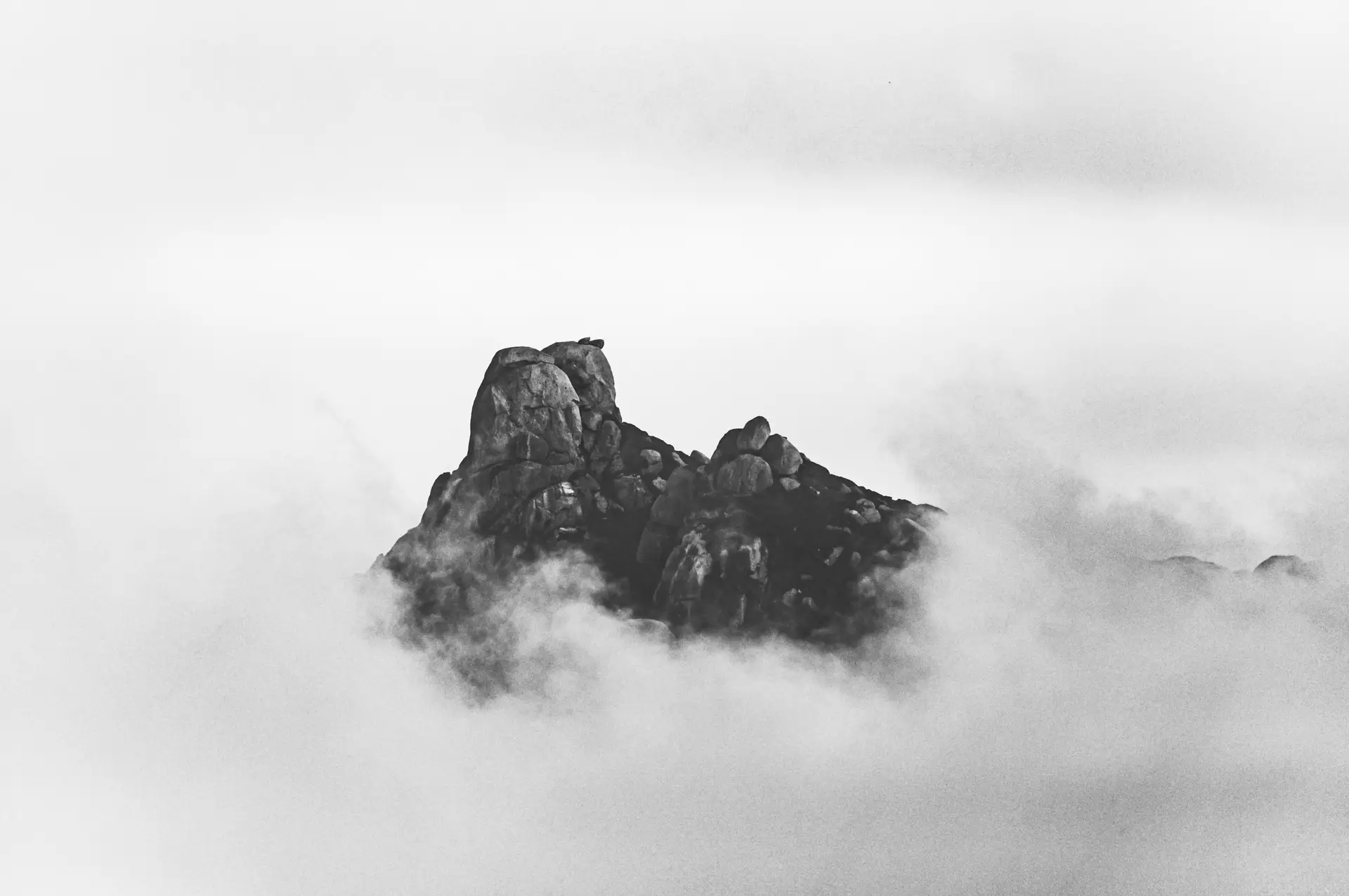 a_mountain_with_clouds_in_the_sky.jpg