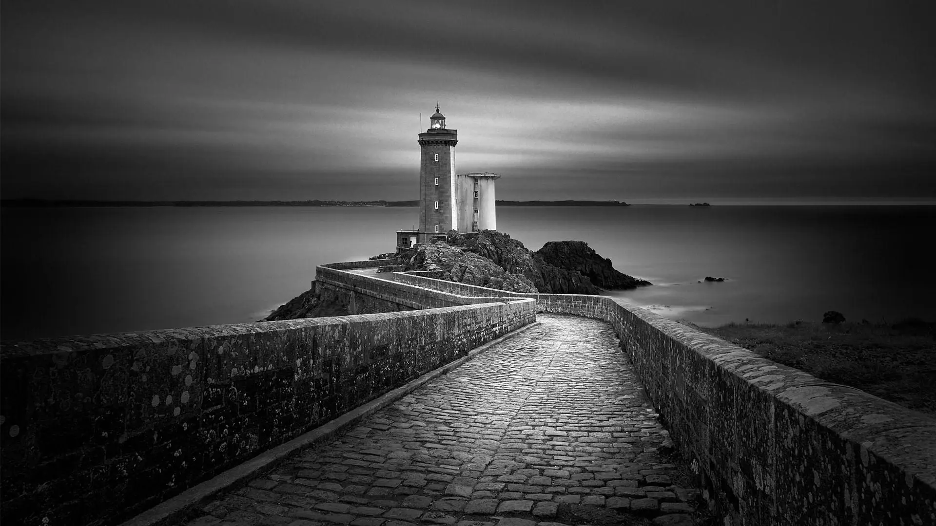 a_stone_walkway_leading_to_a_lighthouse.jpg