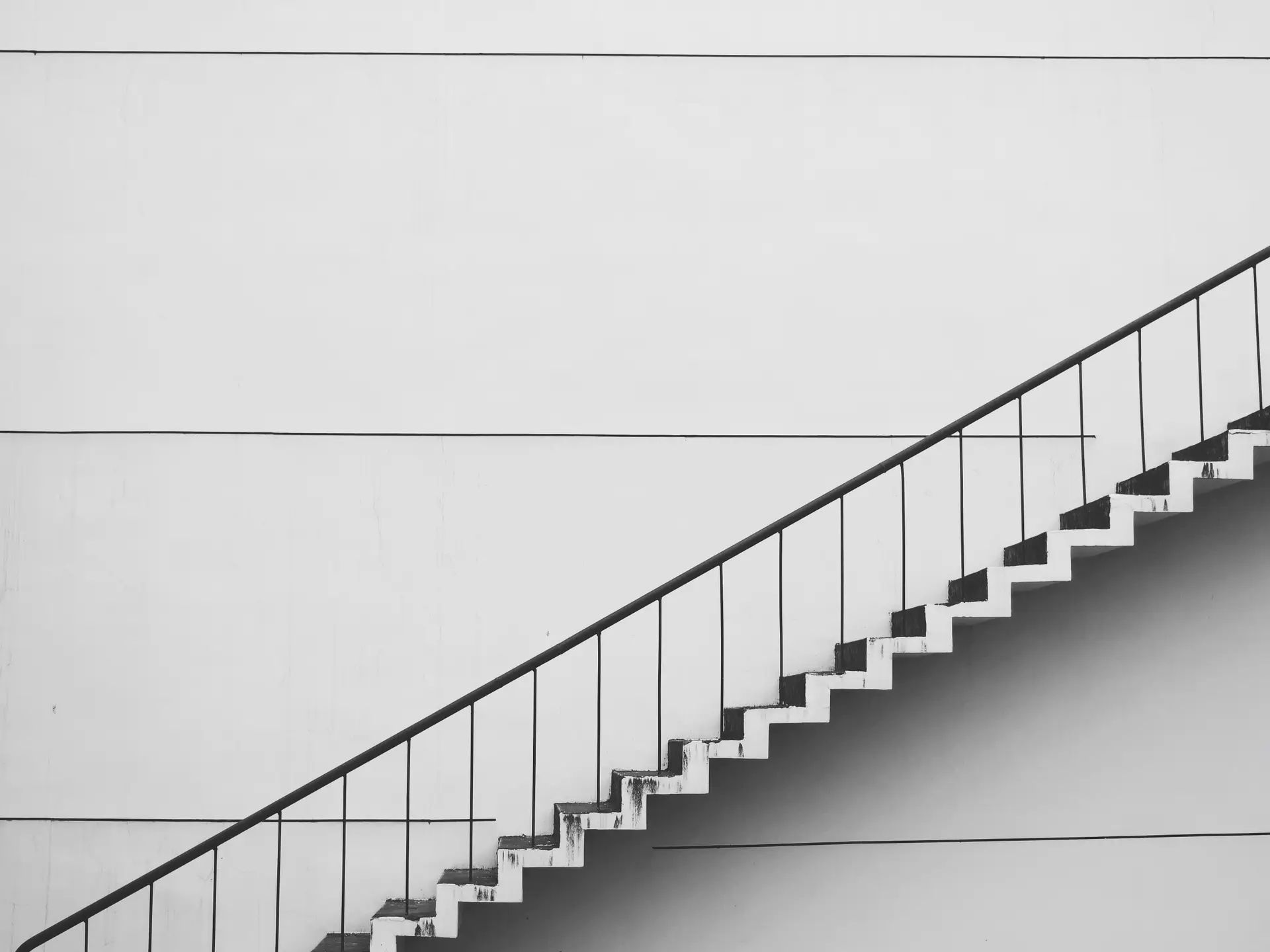 a_white_staircase_with_a_handrail.jpg