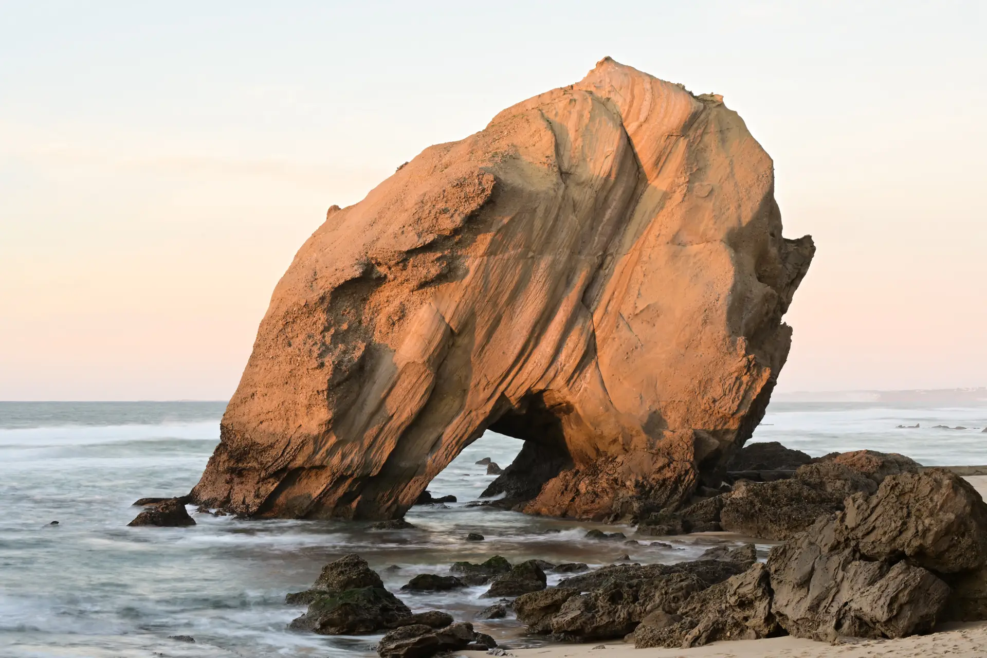 a_large_rock_formation_on_a_beach.jpg