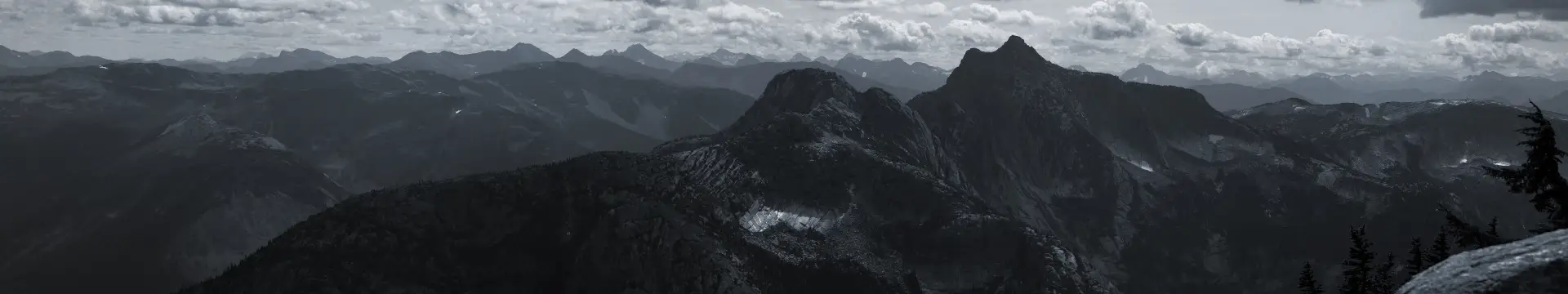 a_mountain_range_with_clouds_in_the_background.jpg