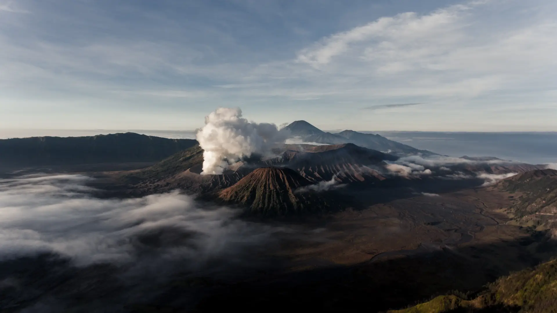 a_mountain_with_smoke_coming_out_of_it.jpg