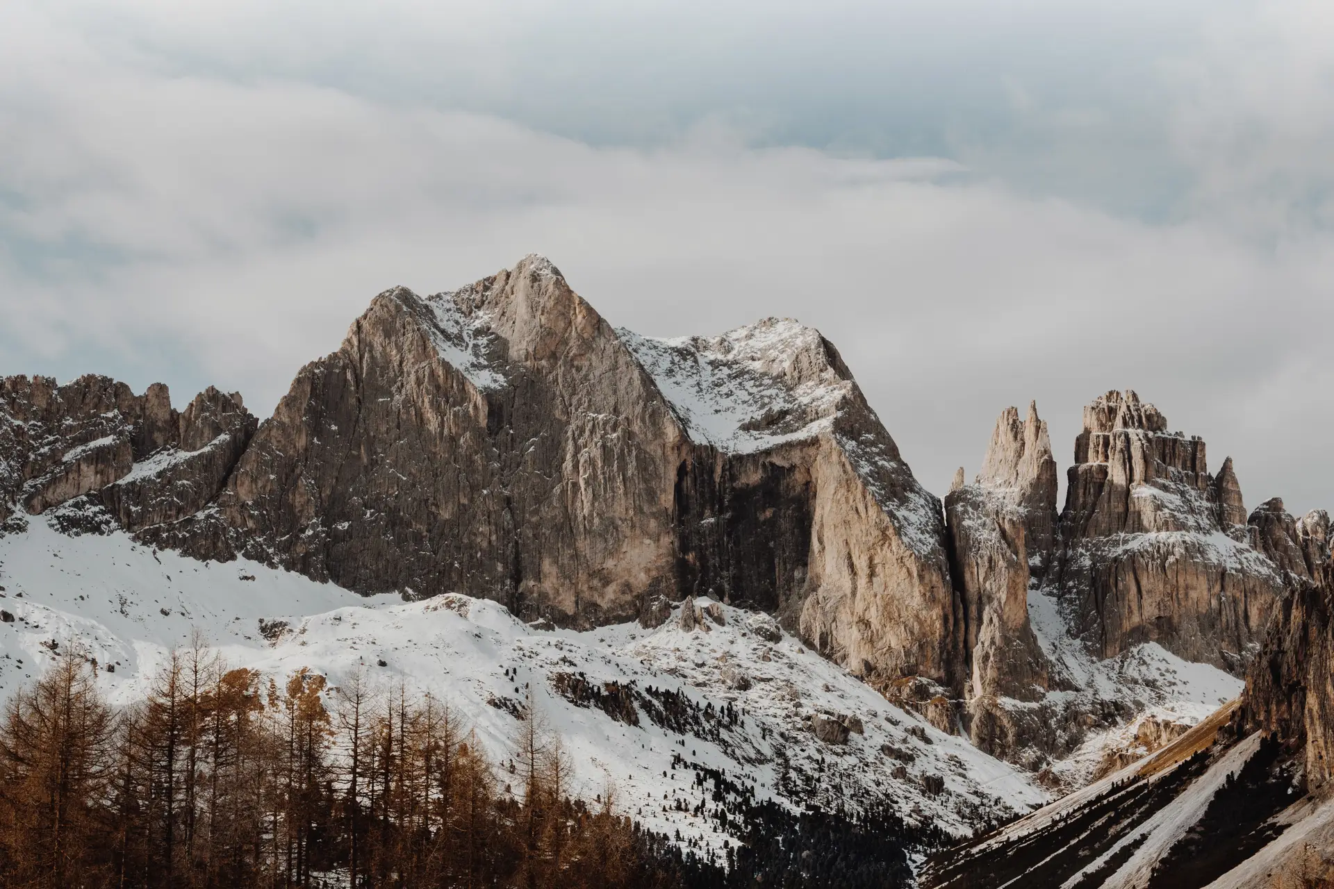 a_snowy_mountain_range_with_trees.jpg