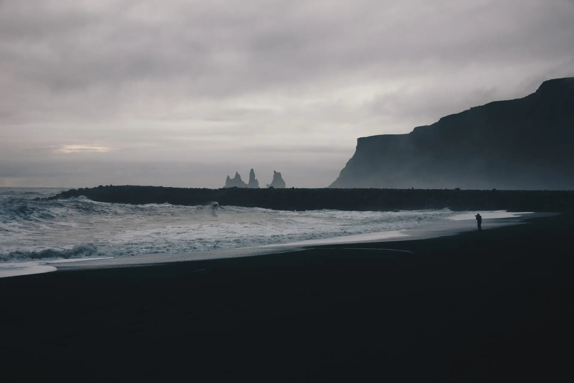 a_beach_with_waves_and_cliffs.jpg