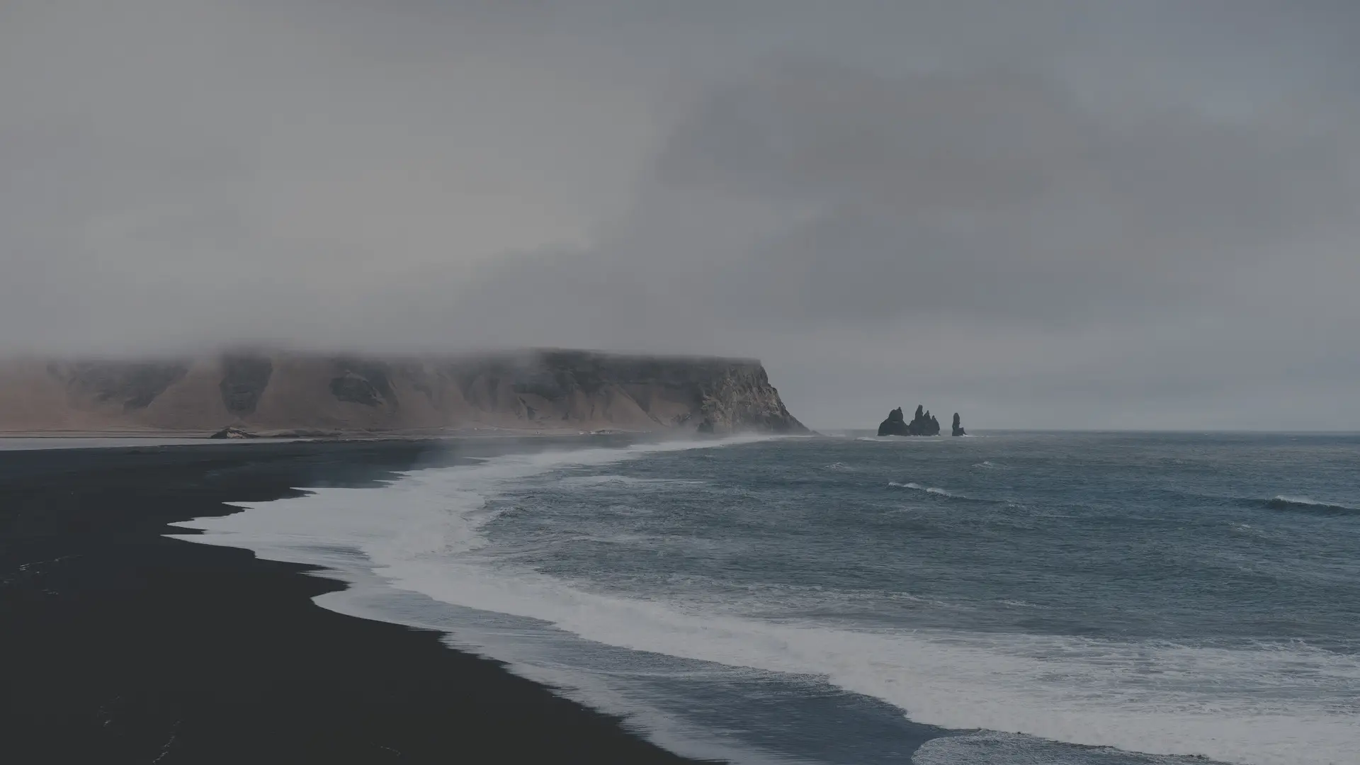 a_beach_with_waves_and_rocks.jpg