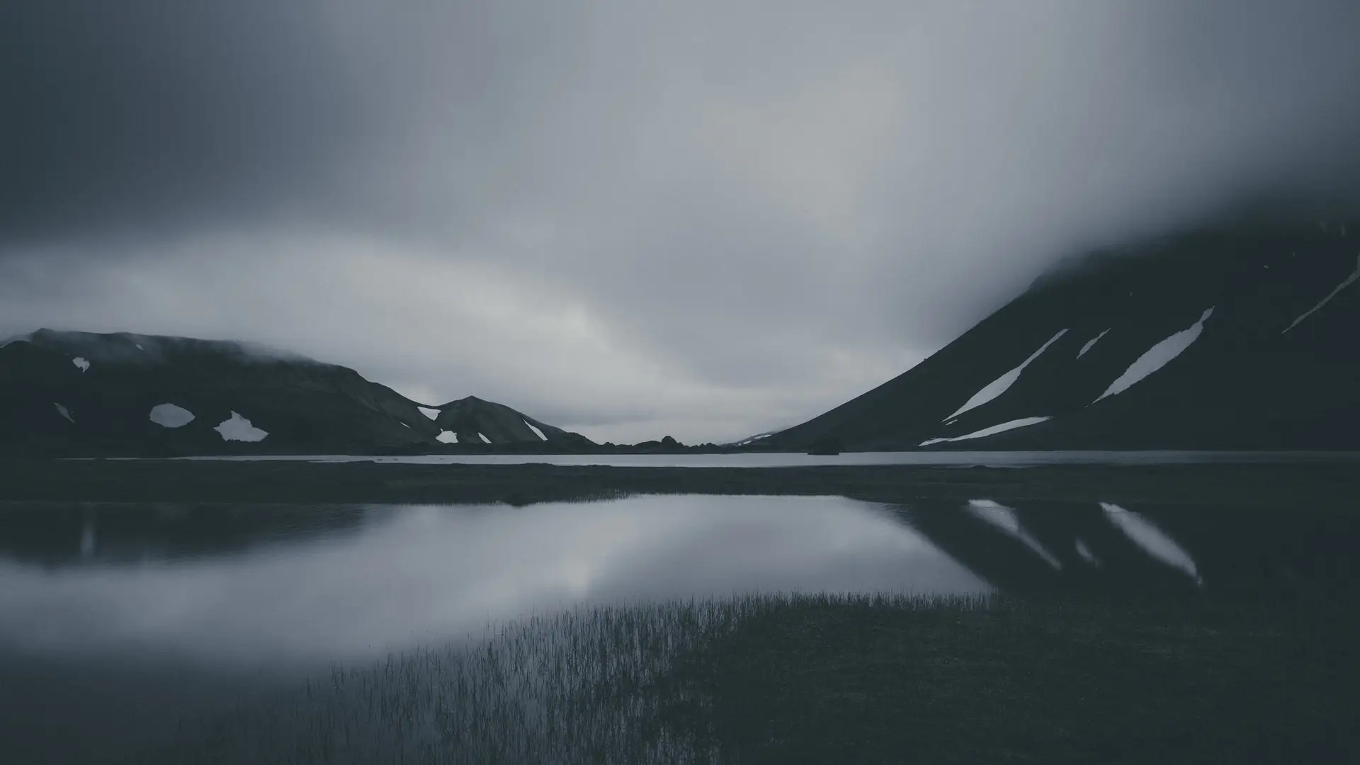 a_lake_with_snow_covered_mountains_in_the_background.jpg