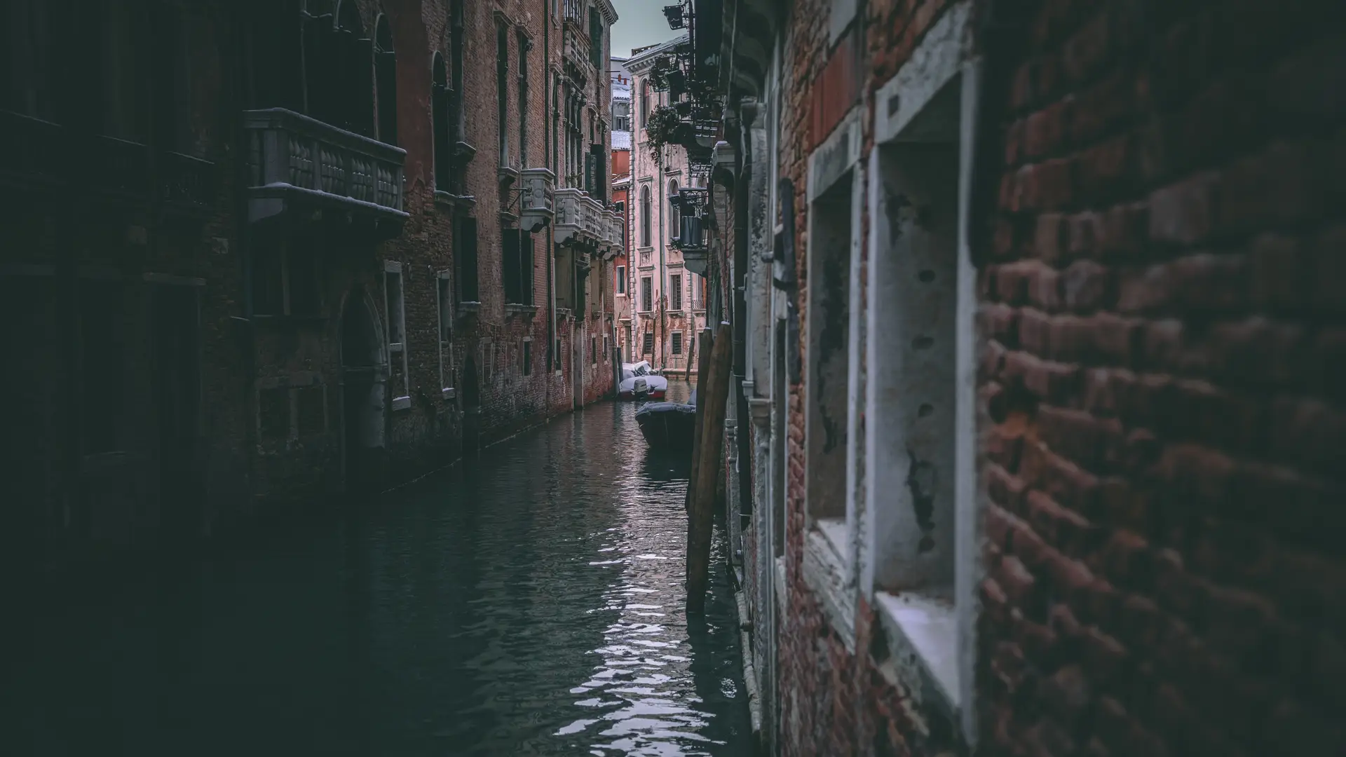 a_canal_between_buildings_with_boats.jpg